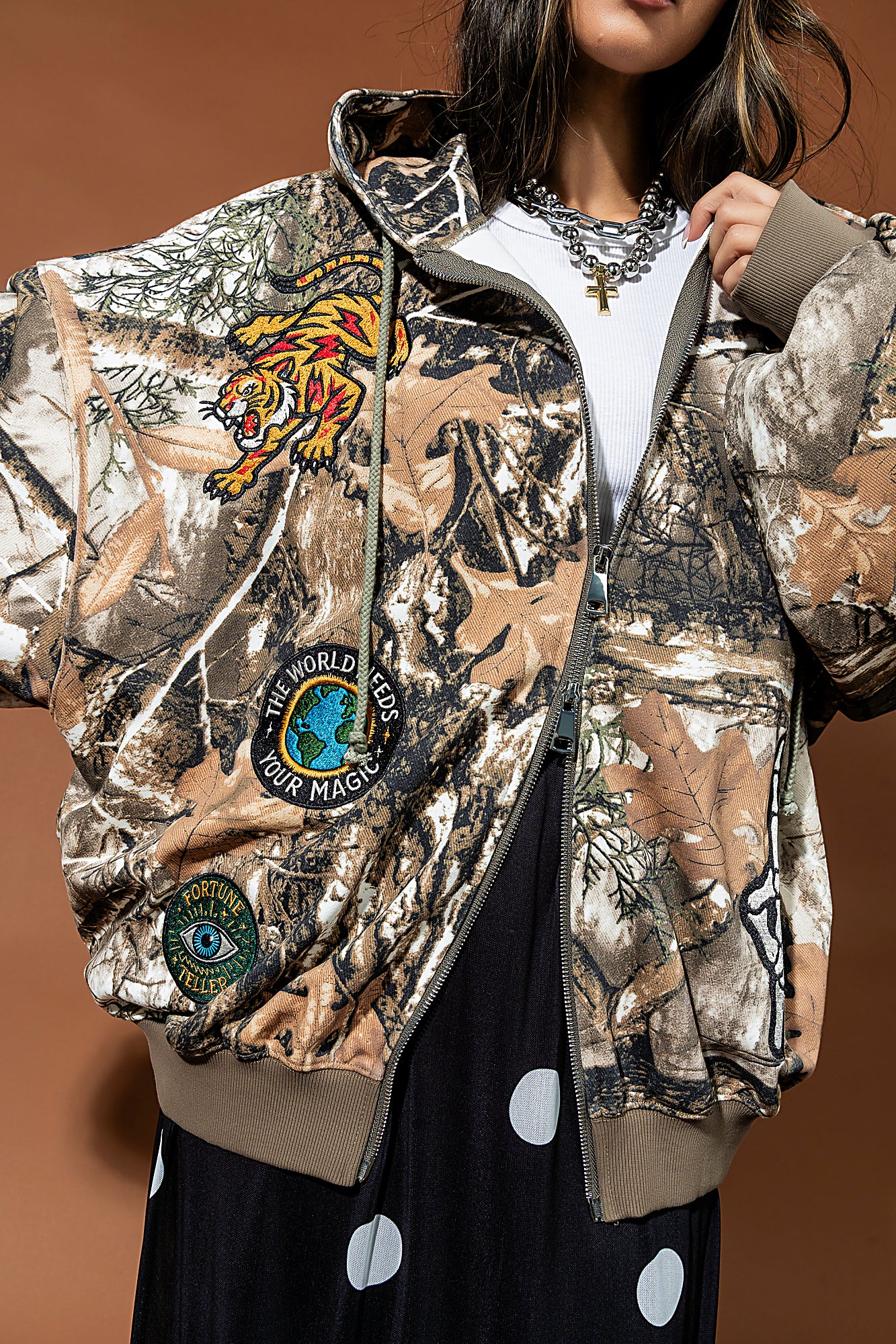 Camouflage jacket with embroidered designs on a brown background