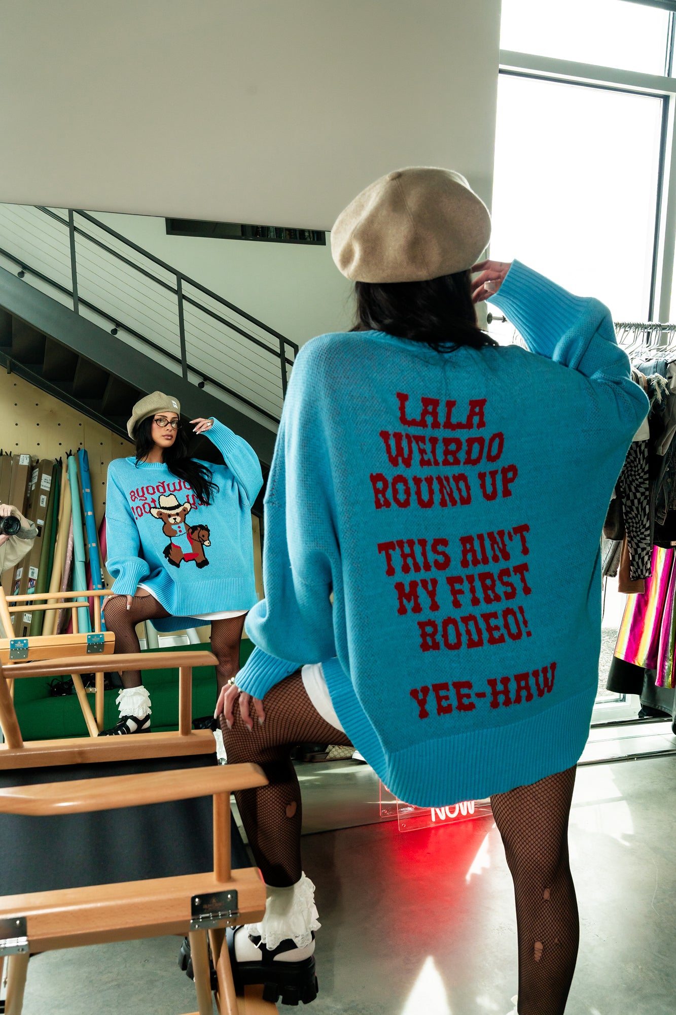 Ain't My First Rodeo Oversized Cotton-Blend Sweater - girl wearing light blue oversized sweater with cowboy riding horse with tear streaming down his face and says "cowboys cry too!" in red on the front and "lala weirdo round up" "this ain't my first rodeo!" and "yee-haw" in red on the back