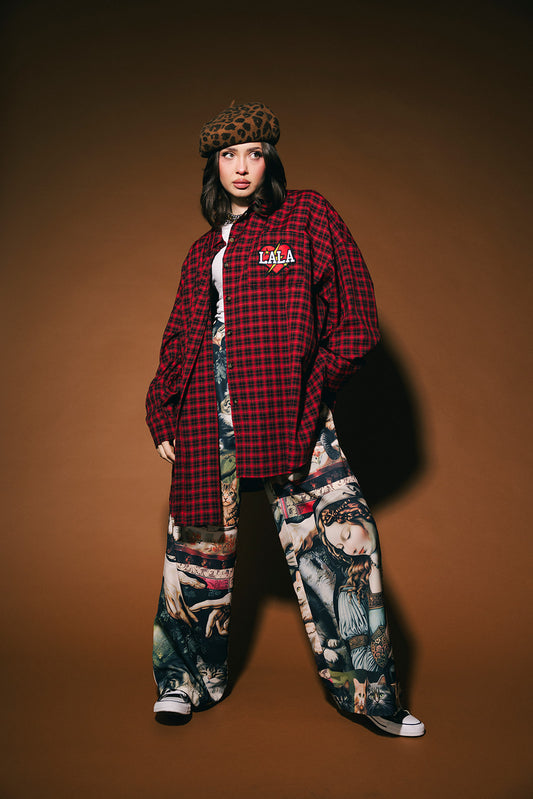 Person wearing a red plaid shirt, patterned pants, and leopard print hat on a brown background