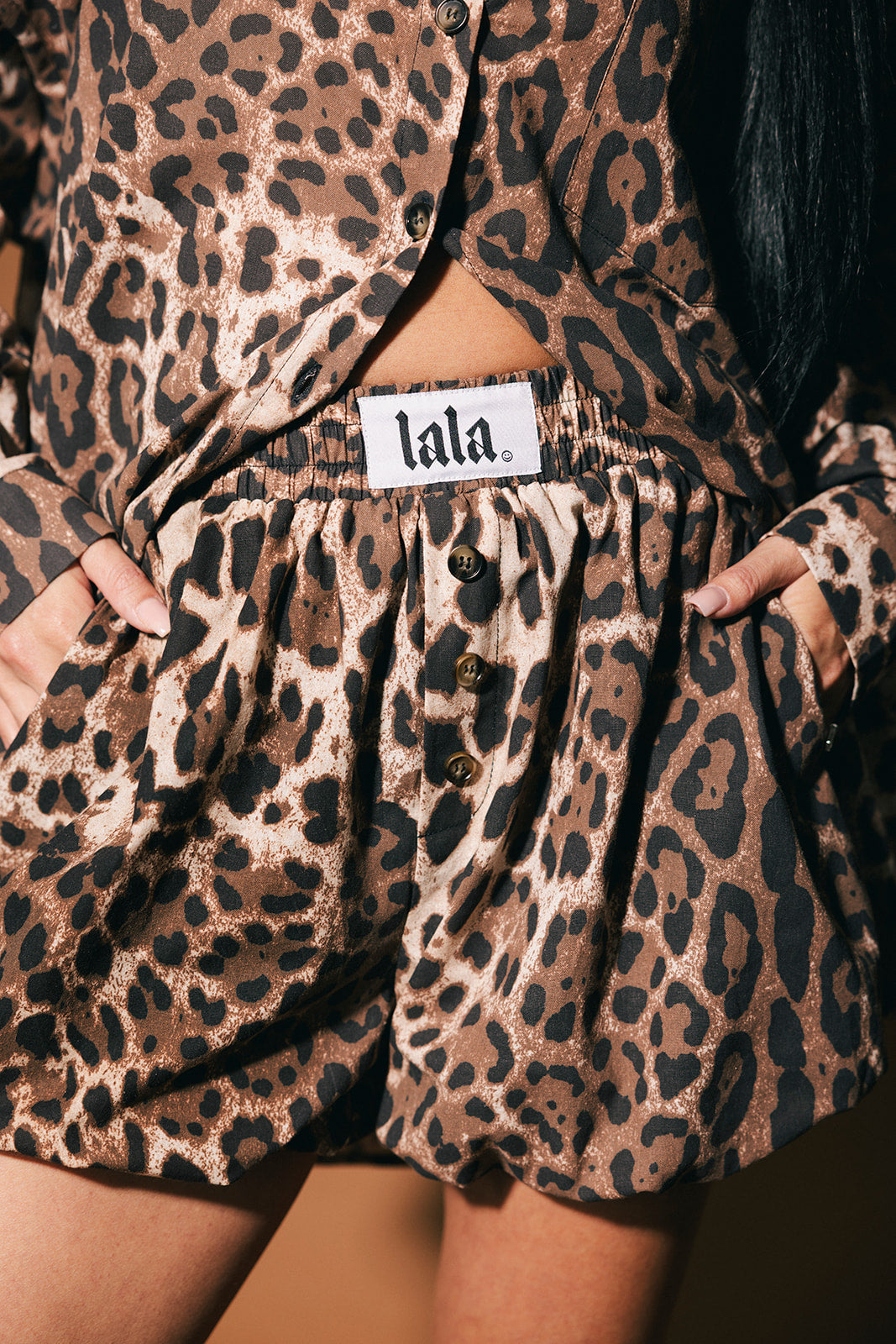 Leopard print shorts with a visible brand label on a dark background