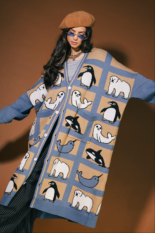 Woman wearing a patterned cardigan with animals on a brown background