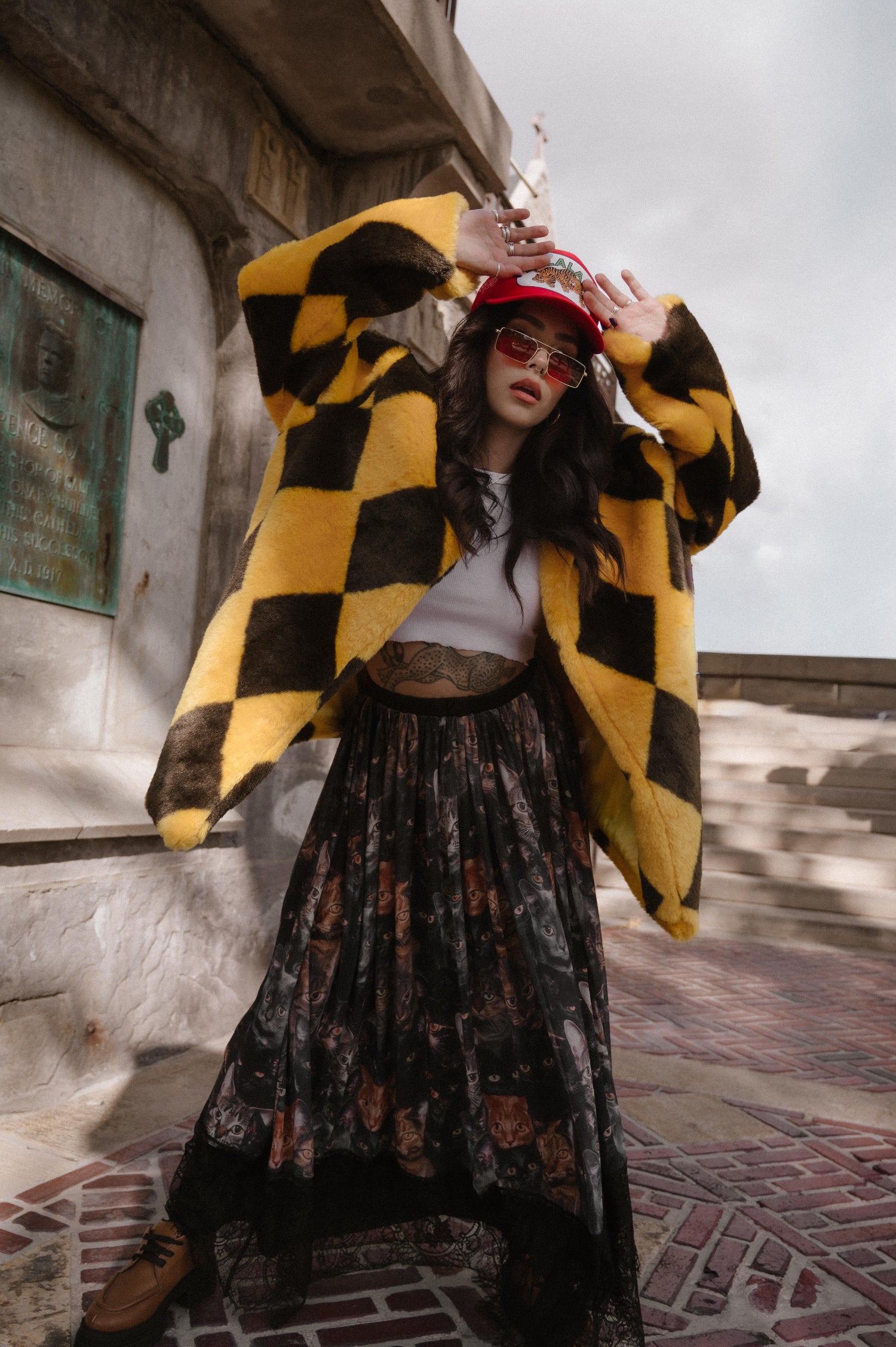Person wearing a yellow and brown diamond faux fur coat in an urban setting