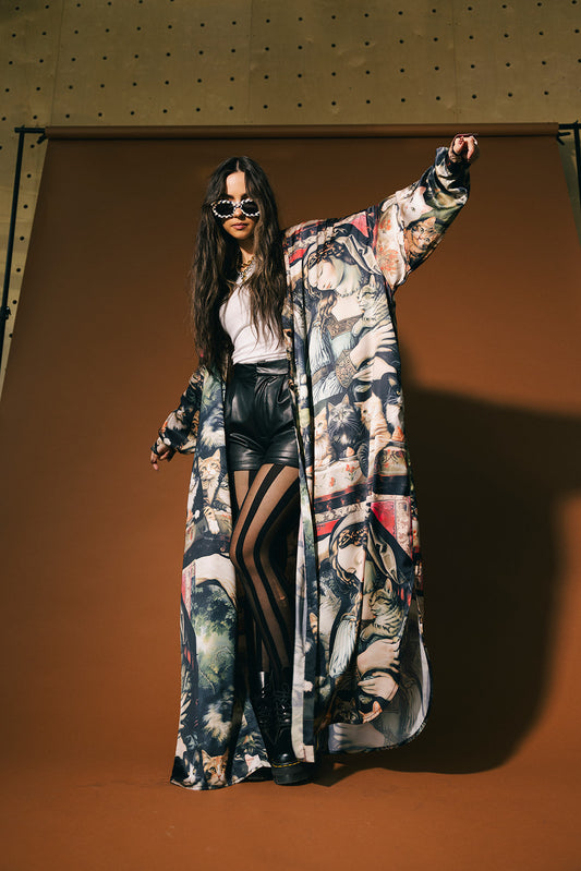 Woman wearing a renaissance cat pattern satin duster against a brown background.