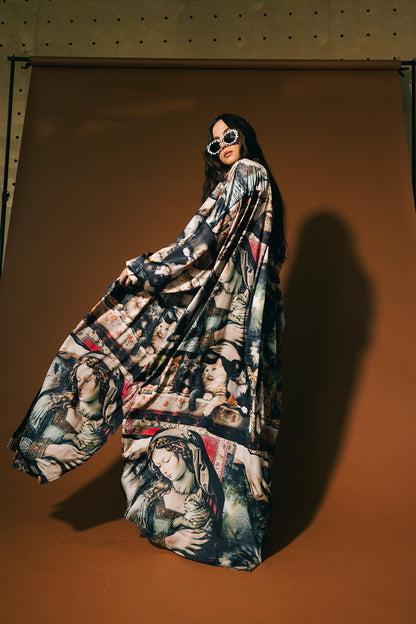 Person wearing a long, cat renaissance pattern satin duster against a brown background