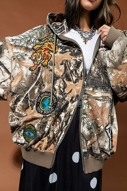 Camouflage jacket with embroidered designs on a brown background