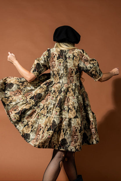 Woman in a dog patterned dress and black beret twirling against a brown background