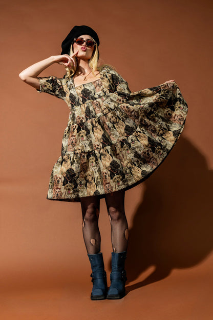 Woman in a dog dress and black boots posing against a brown background