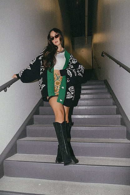 Woman in a stylish outfit standing on a staircase