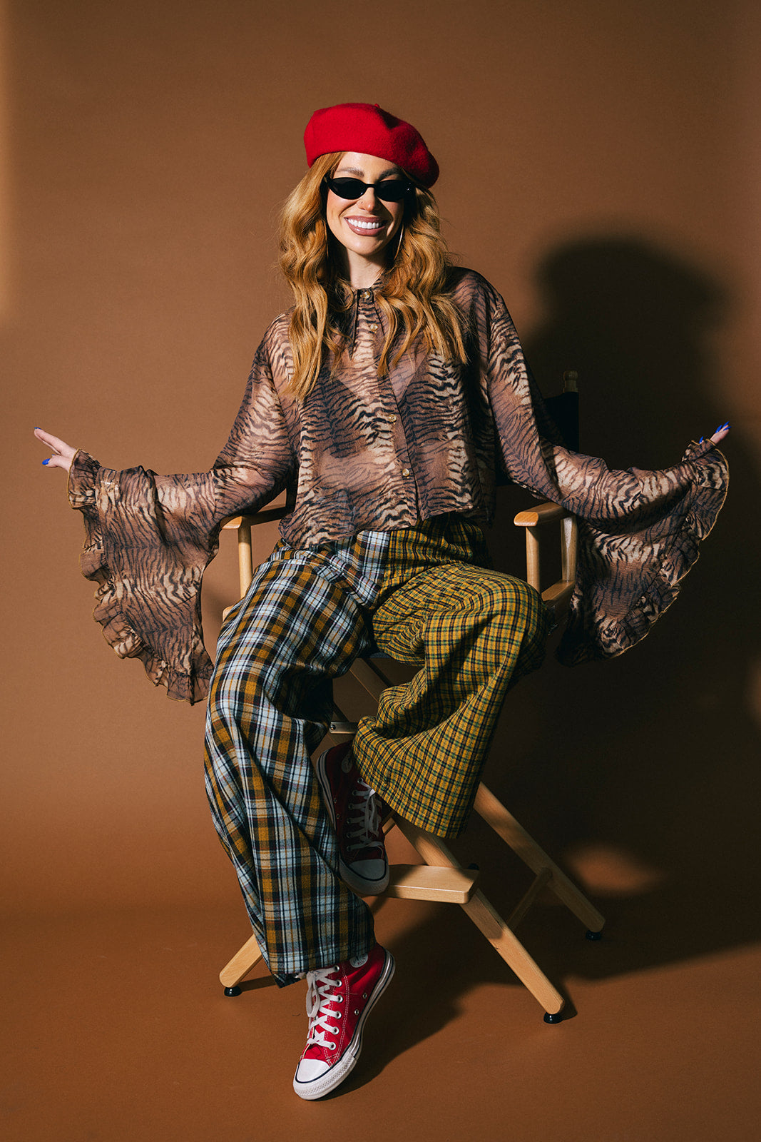 Person wearing plaid half and half trousers on a brown background