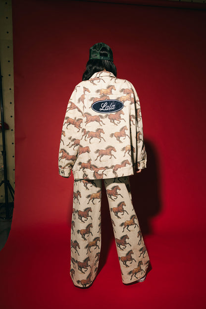 White denim jacket with a horse pattern and Lala logo on a red background