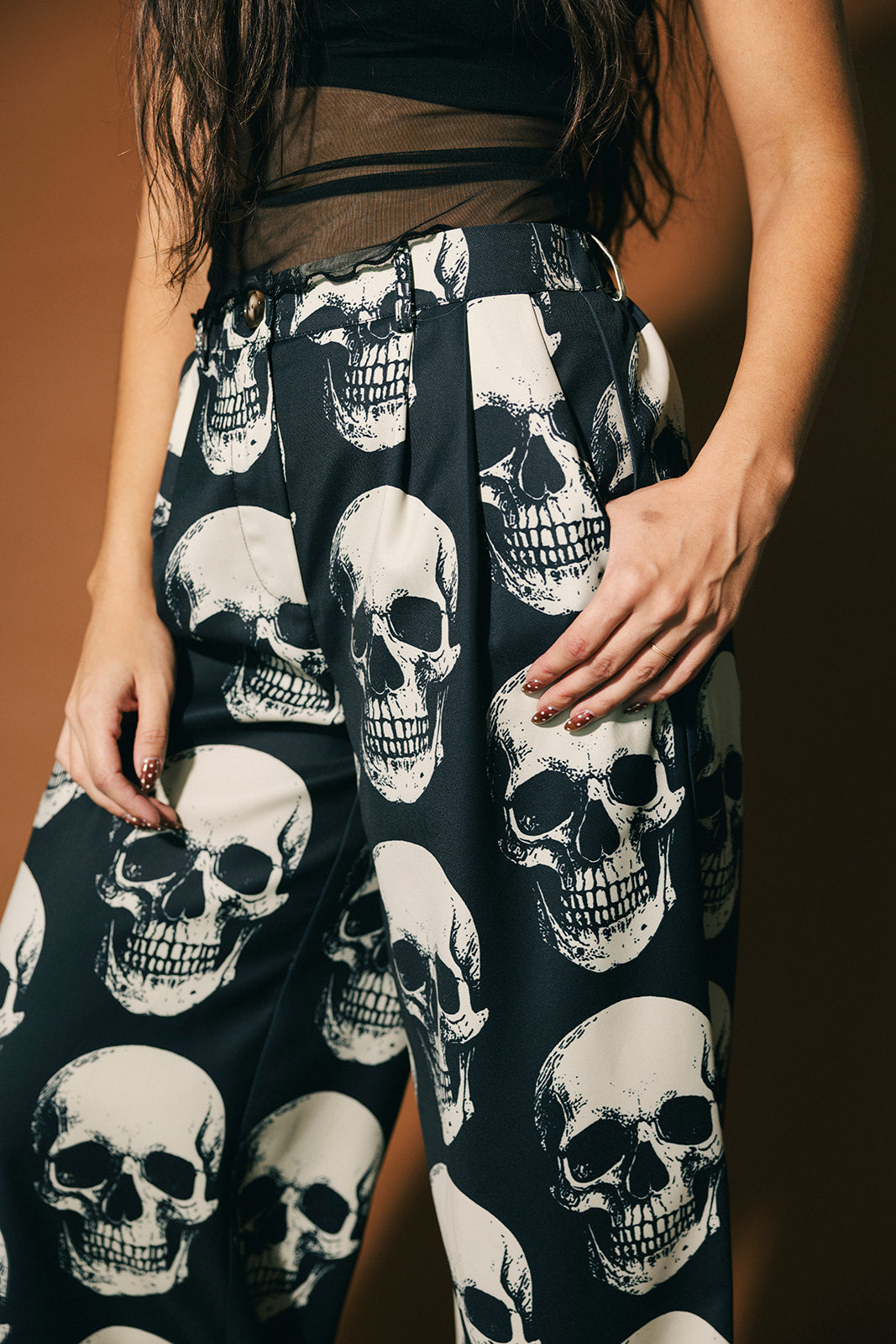 Close up of black trousers with skull pattern.