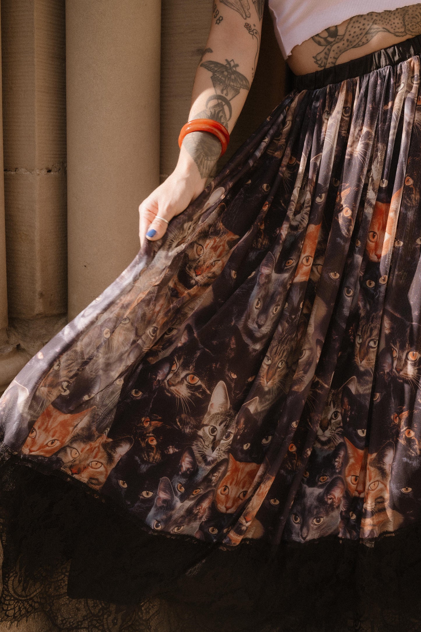 Close up of cat pattern mesh skirt with lace hem.