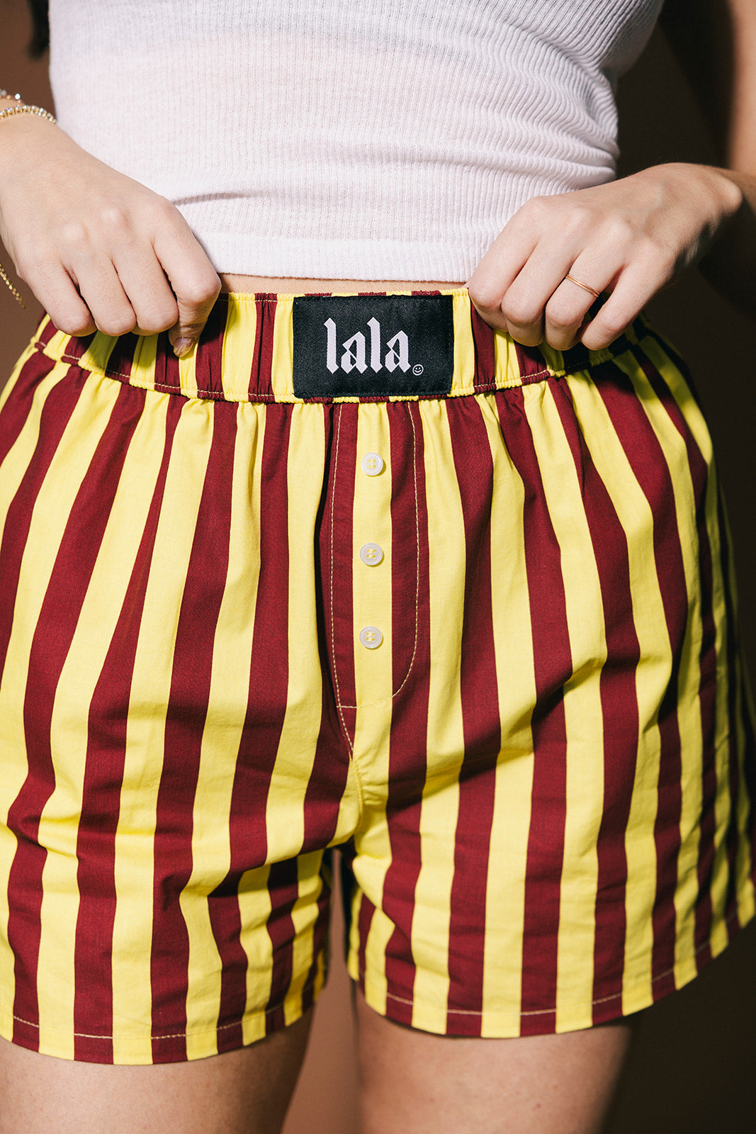 Maroon and yellow striped boxer briefs with 'lala' label.