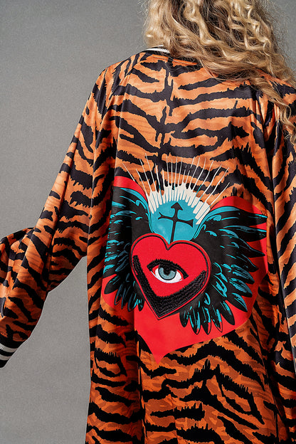 Tiger-striped robe with a red heart and blue eye design on a gray background