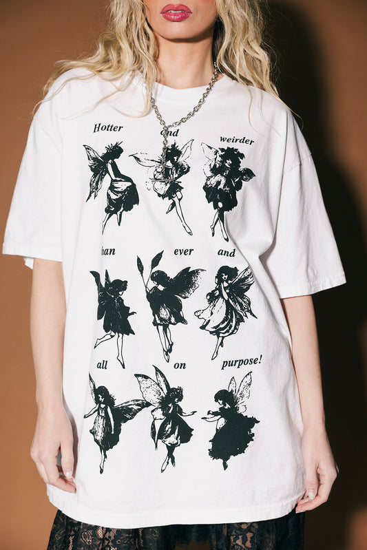 White t-shirt with black fairy illustrations and text worn by a person.