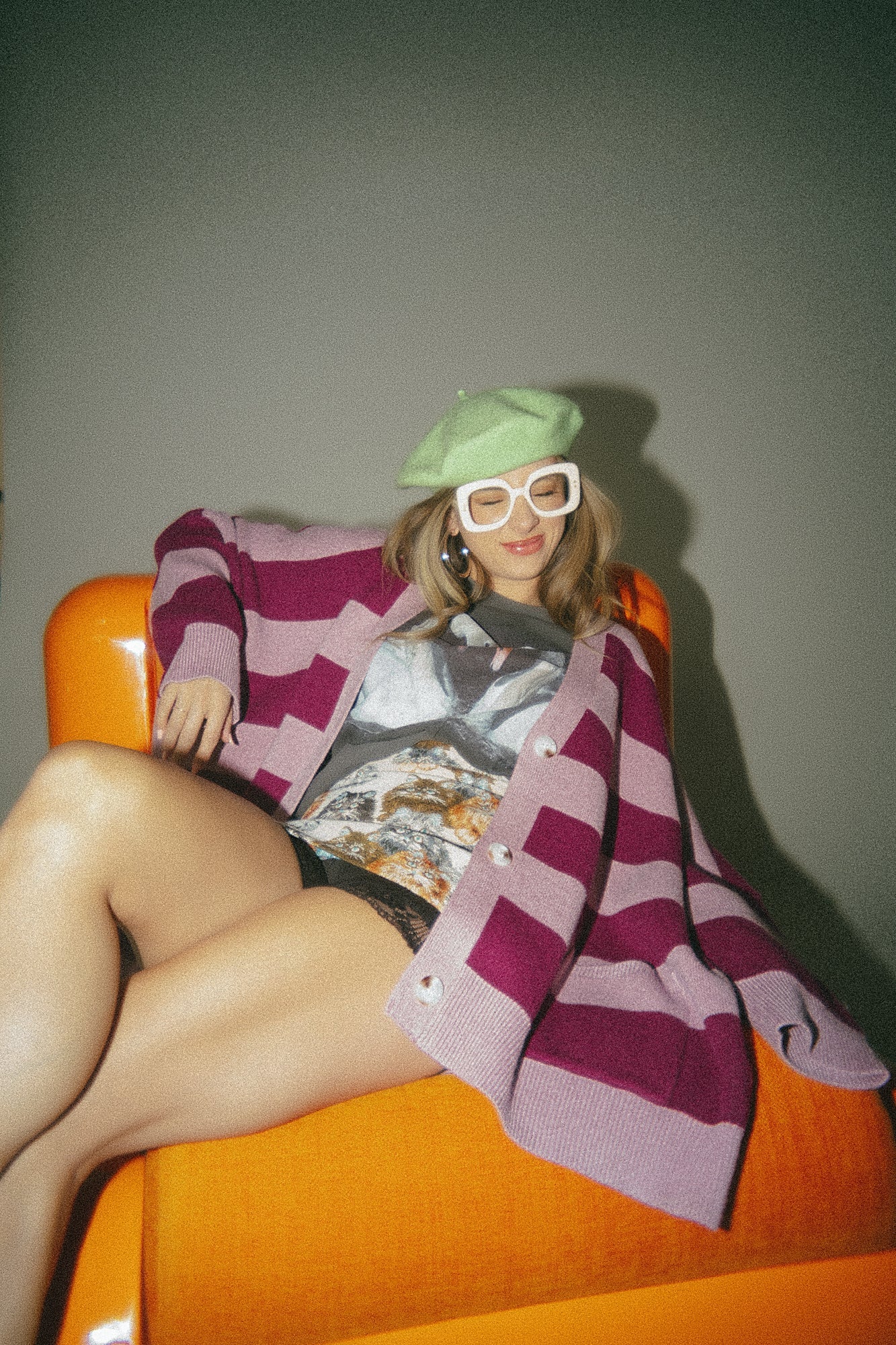 Elise is wearing a size S/M Love You Oversized Cardigan in Wonderland Stripes  with the Let's Be Weirdos Together Swan Boxy Tee.