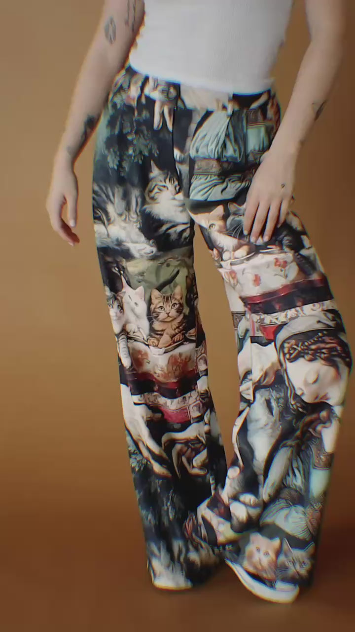 Video of woman wearing trousers with design of cats eating at the Last Supper.